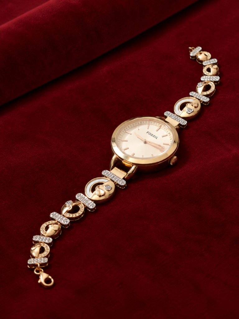 fossil gold watch on burgundy velvet