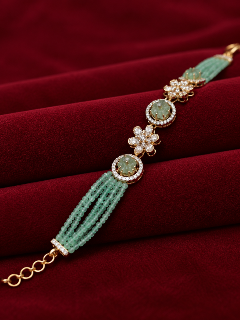 mint green and gold bracelet on burgundy velvet