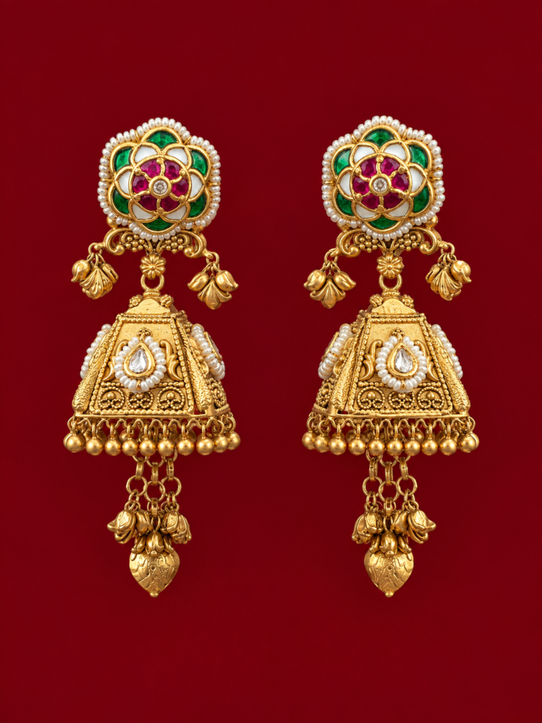 ornate gold jhumka pair on burgundy